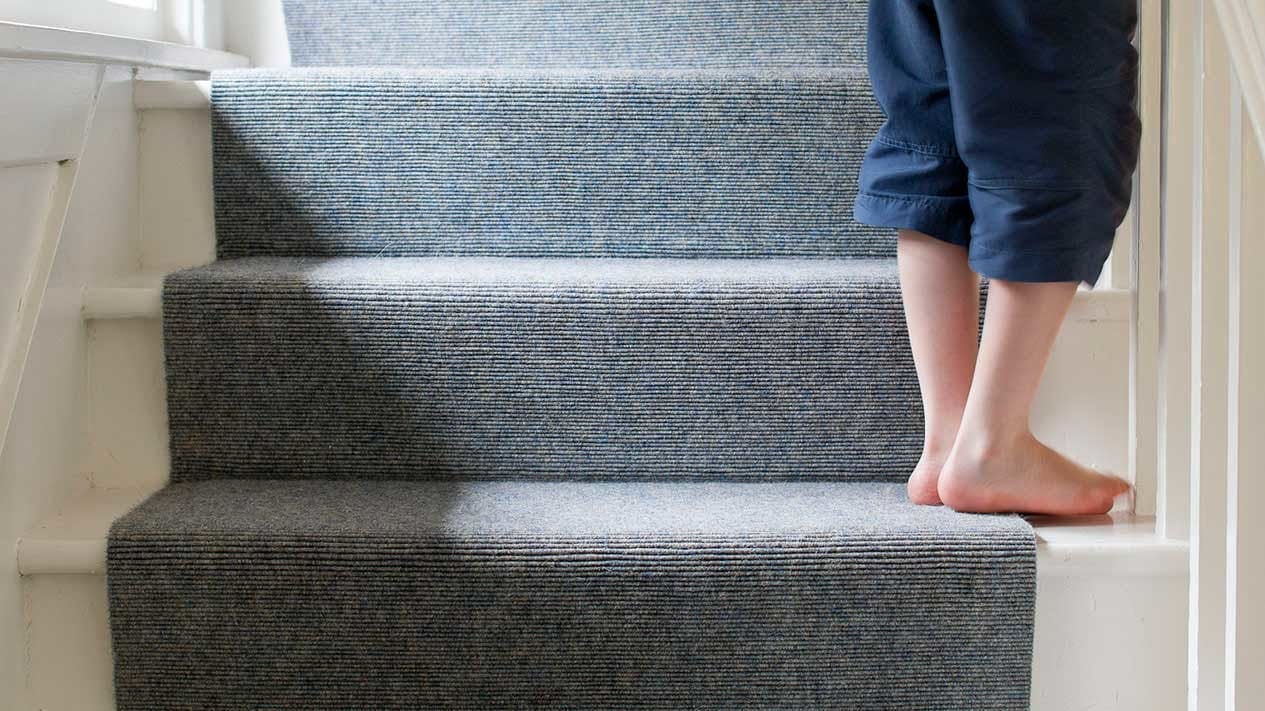 Natural grey stair runner on white staircase
