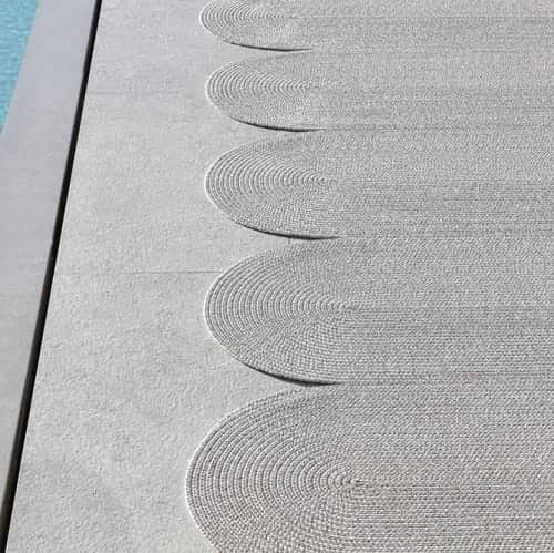 organic shapes: poolside serpentine outdoor rug shown in color carrara