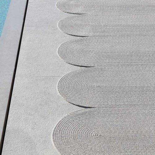 organic shapes: poolside serpentine outdoor rug shown in color carrara