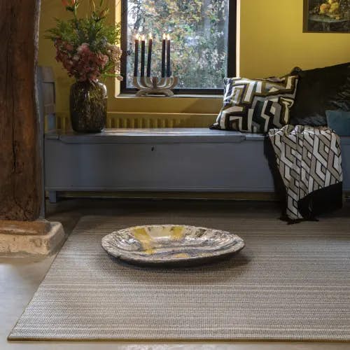 Masai Nude wool rug with blind soft border in rustic room