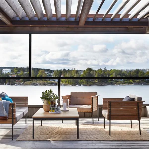 Fiji Jute Natural area rug on covered patio deck with minimalist outdoor furniture